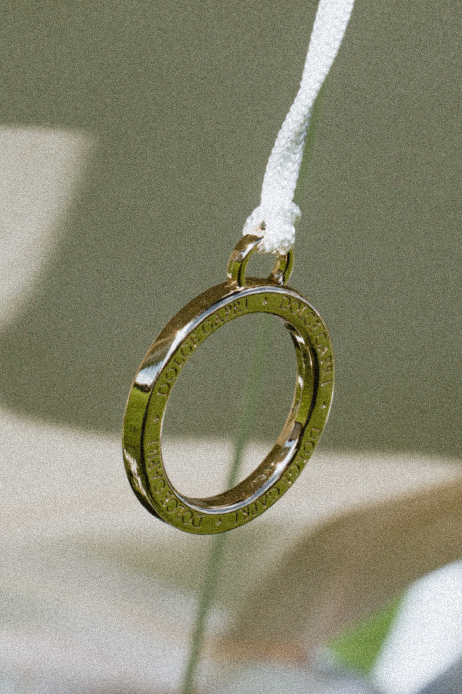 Back view of folded Dolce Capri Tuscan Olive sun lounger with branded canvas shade.